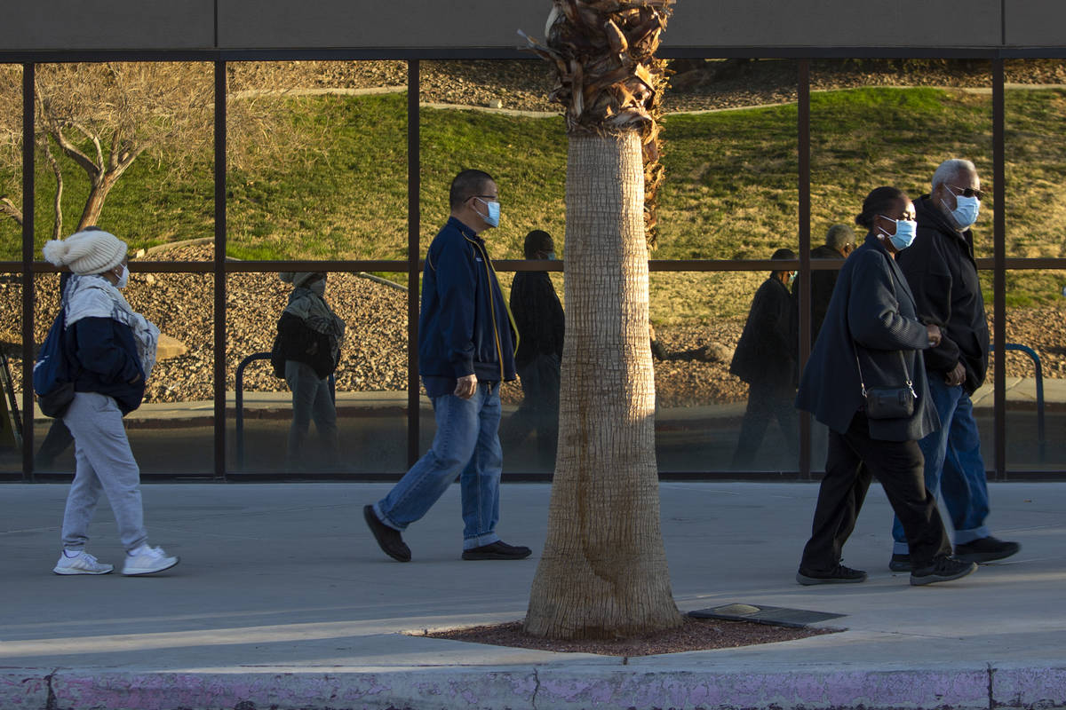 People wait in line for their COVID-19 vaccine at Cashman Field on Saturday, Feb. 20, 2021, in ...