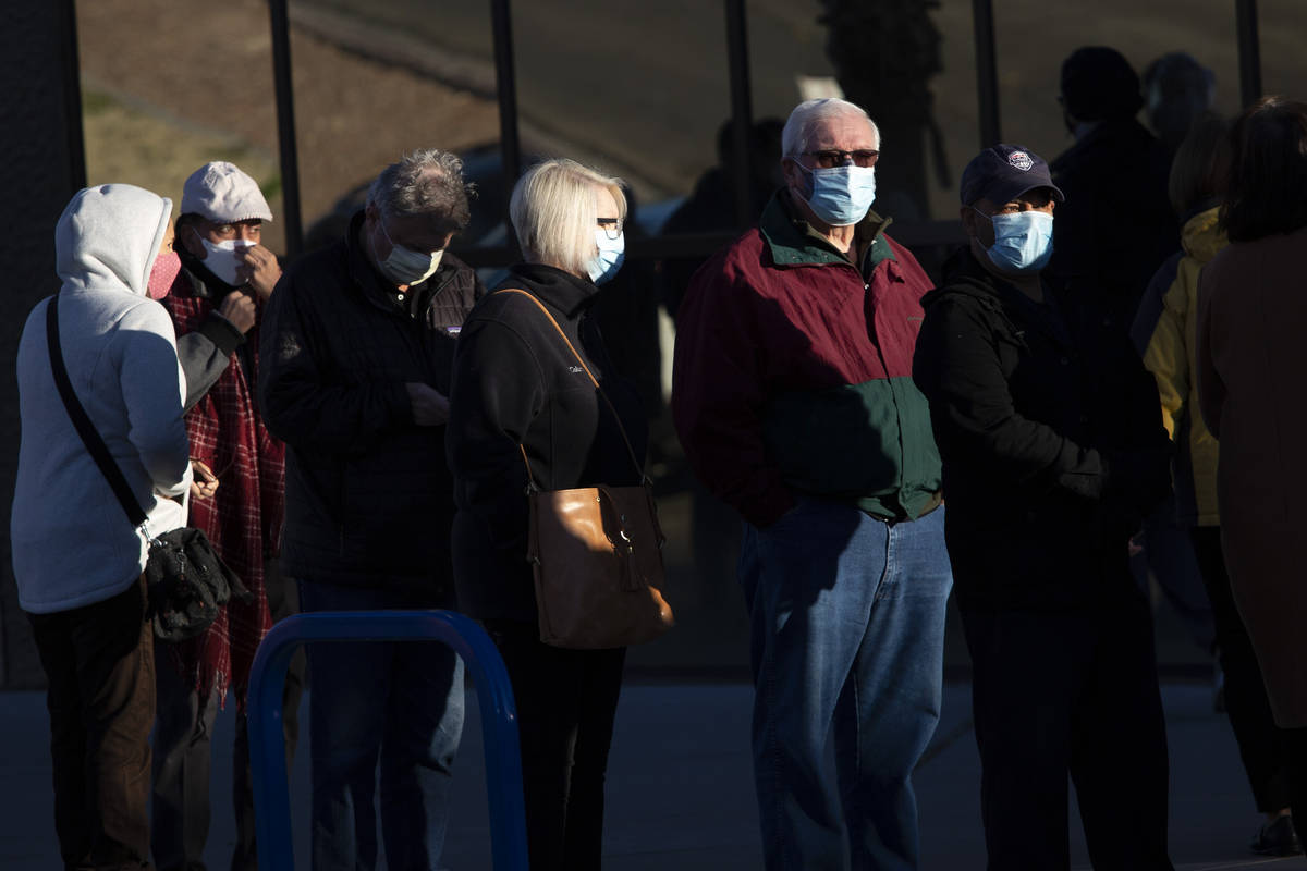 People wait in line for their COVID-19 vaccine at Cashman Field on Saturday, Feb. 20, 2021, in ...