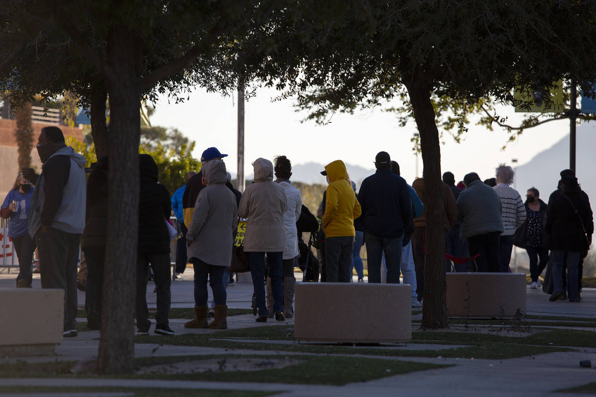 People wait in line for their COVID-19 vaccine at Cashman Field on Saturday, Feb. 20, 2021, in ...