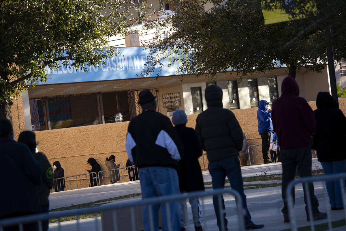 People wait in line for their COVID-19 vaccine at Cashman Field on Saturday, Feb. 20, 2021, in ...