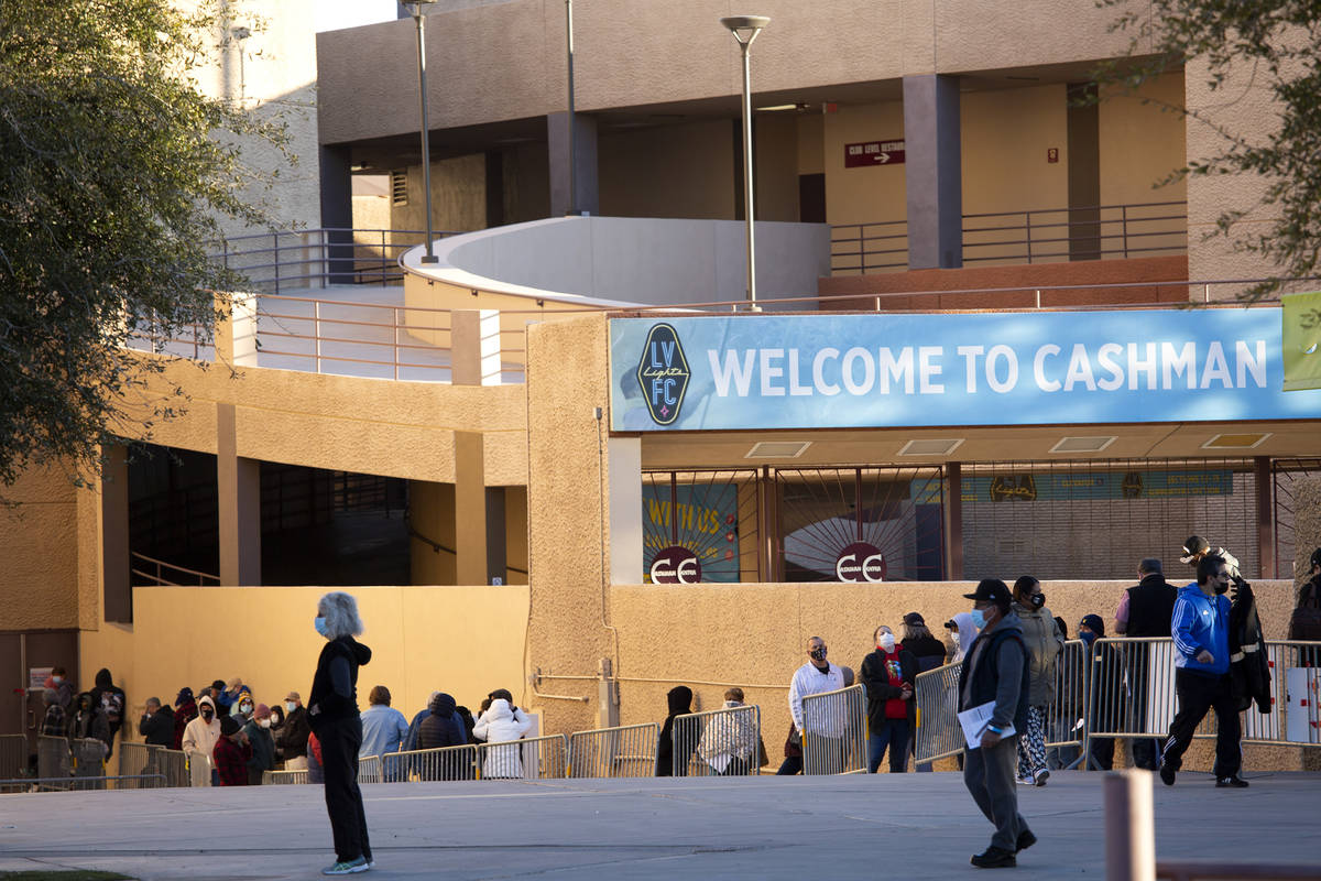 People wait in line for their COVID-19 vaccine at Cashman Field on Saturday, Feb. 20, 2021, in ...