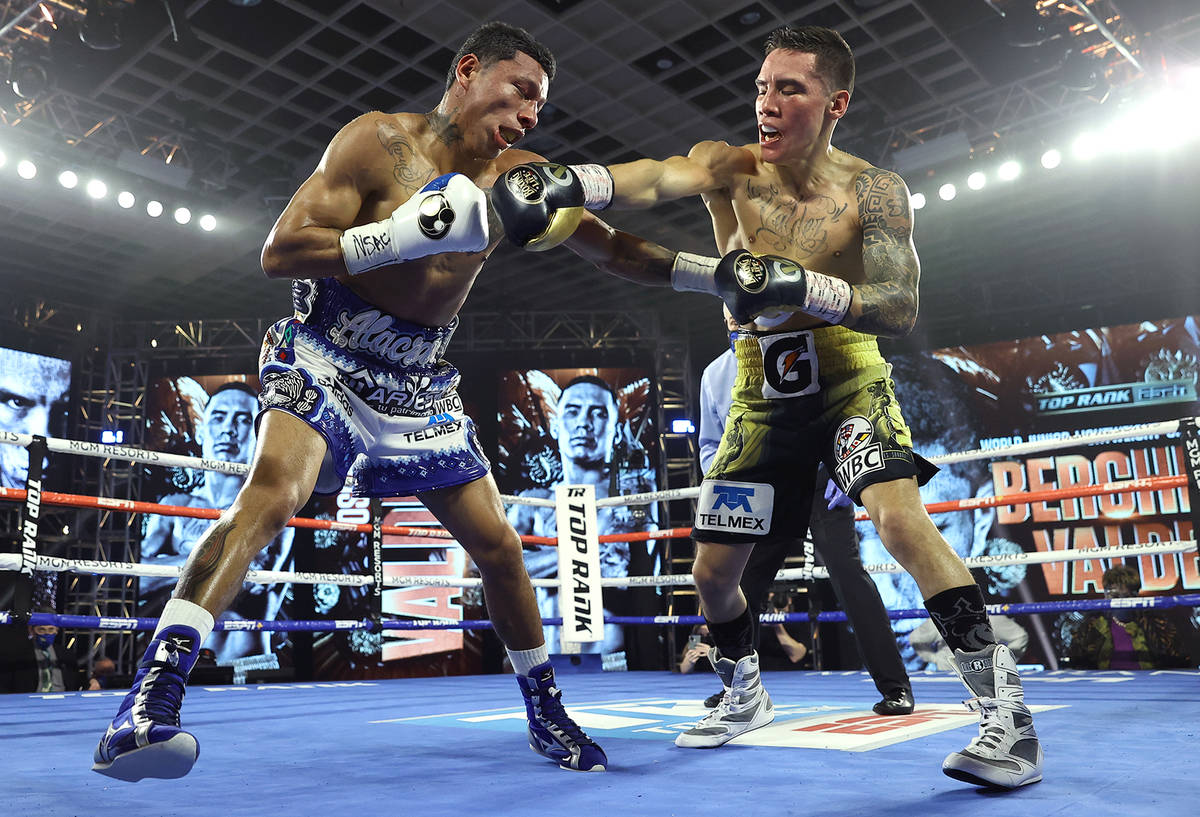 Miguel Berchelt, left, and Oscar Valdez exchange punches during their fight for the WBC super f ...