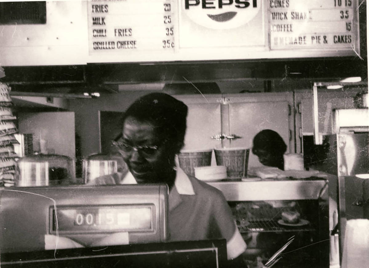 Black and white photograph of "Katherine" at the front counter of Hamburger Heaven No. 1, locat ...