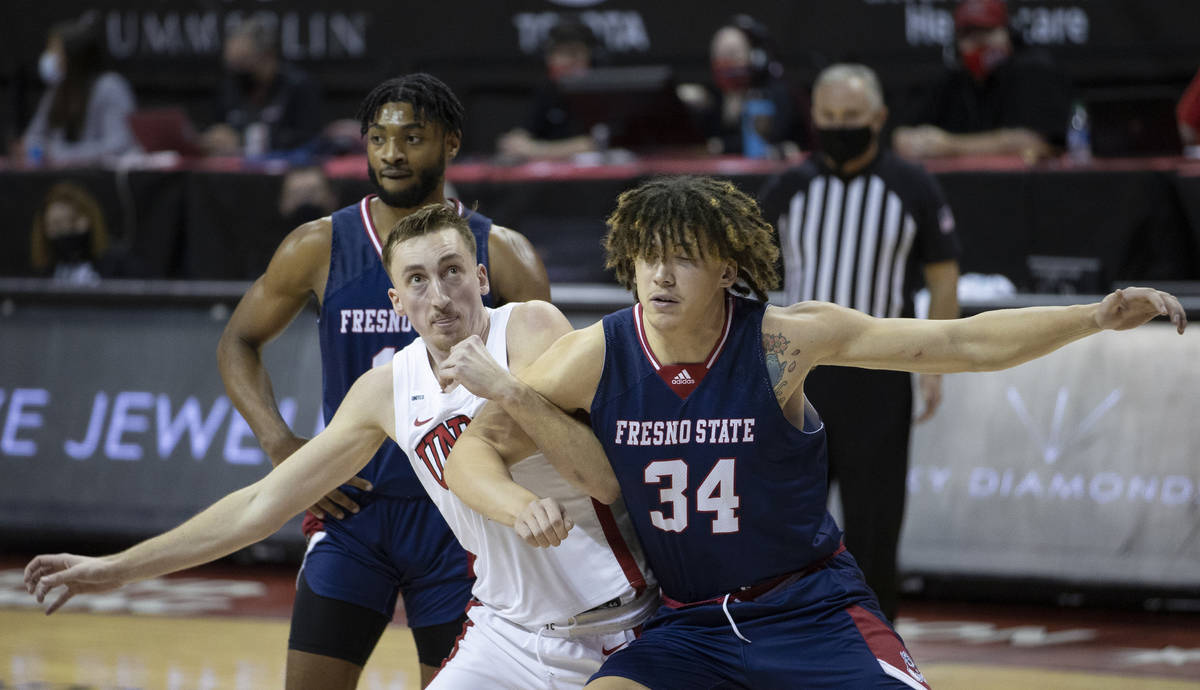 UNLV Rebels forward Moses Wood (1) fights for a loose ball with Fresno State Bulldogs center Br ...