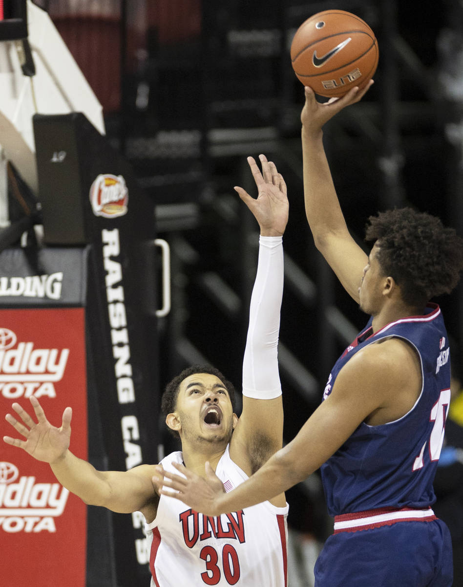 UNLV Rebels forward Devin Tillis (30) extends to try and block the shot of Fresno State Bulldog ...