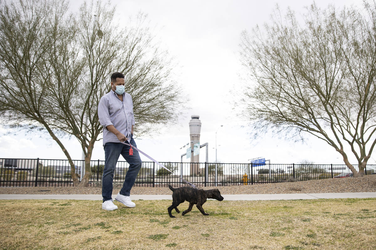 Ronald Pipkins, who was the first presumptive positive case of COVID-19 in Nevada, walks his do ...