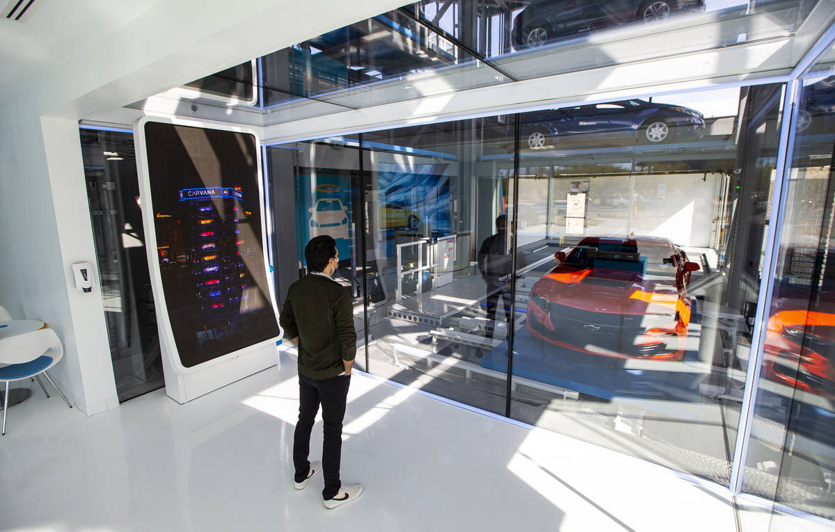 Bryce Bergevin, a vending machine specialist at Carvana, watches as a 2019 Chevrolet Camaro SS ...