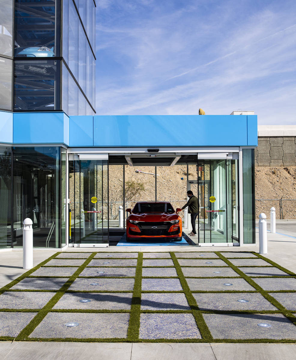 Bryce Bergevin, a vending machine specialist at Carvana, opens the door to a 2019 Chevrolet Cam ...