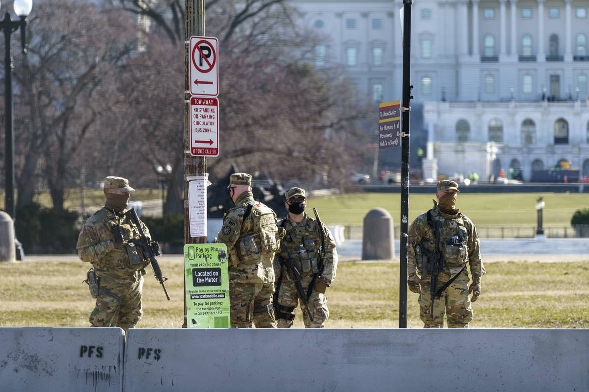 National Guard troops patrol the perimeter of the Capitol in Washington, Thursday, Feb. 25, 202 ...