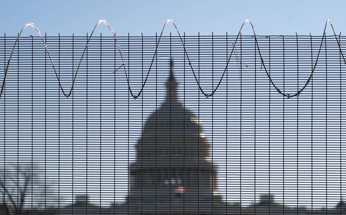 Fencing and razor wire surrounds the perimeter of the Capitol in Washington, Thursday, Feb. 25, ...