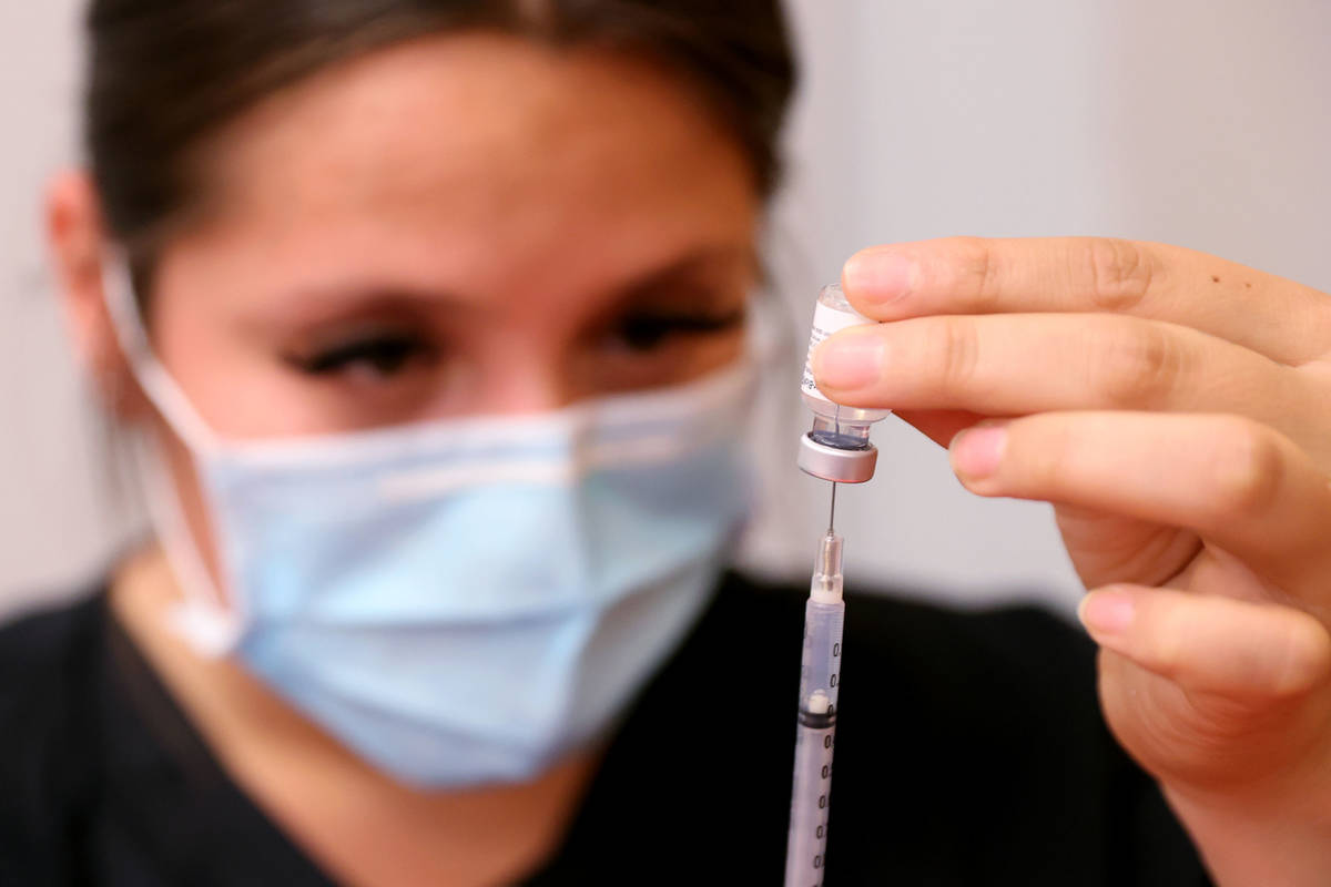 Certified Medical Assistant Selene Ramirez prepares a COVID-19 vaccine during a UNLV Medicine c ...