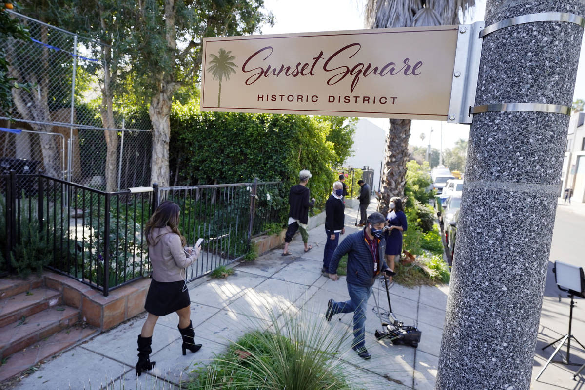Members of the media and neighbors walk near an area on North Sierra Bonita Ave. where Lady Gag ...
