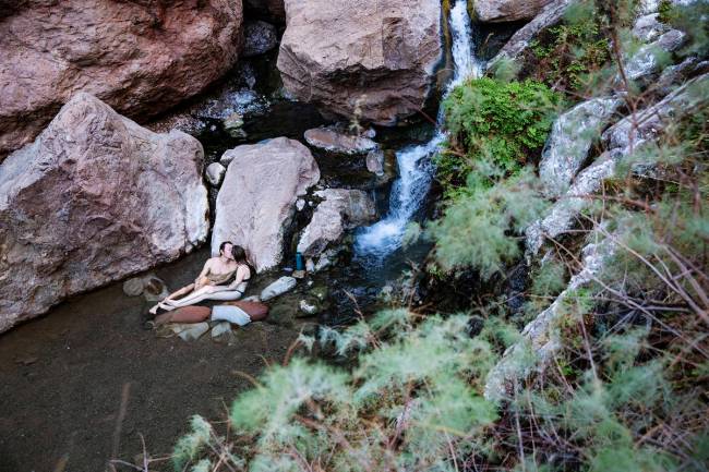 Kellan Lindley and Katelyn Walsh relax in Gold Strike Hot Spring during a two-night camping tri ...