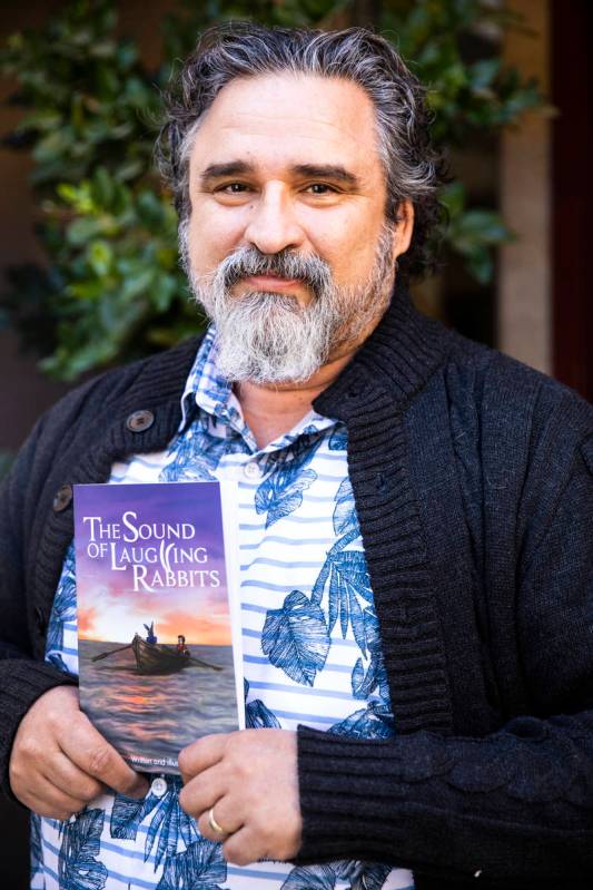Henderson resident Alex Raffi holds "The Sound of Laughing Rabbits," which he wrote and illustr ...