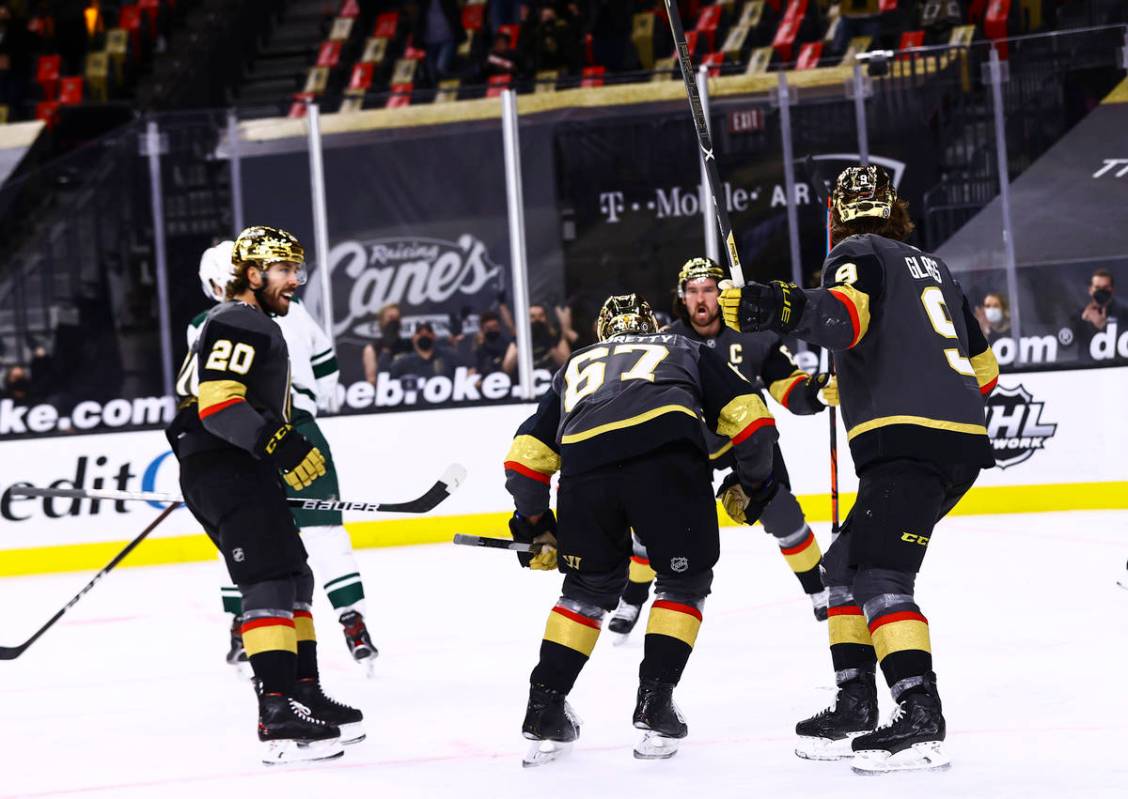 Golden Knights players celebrate a goal by Max Pacioretty during the second period of an NHL ho ...