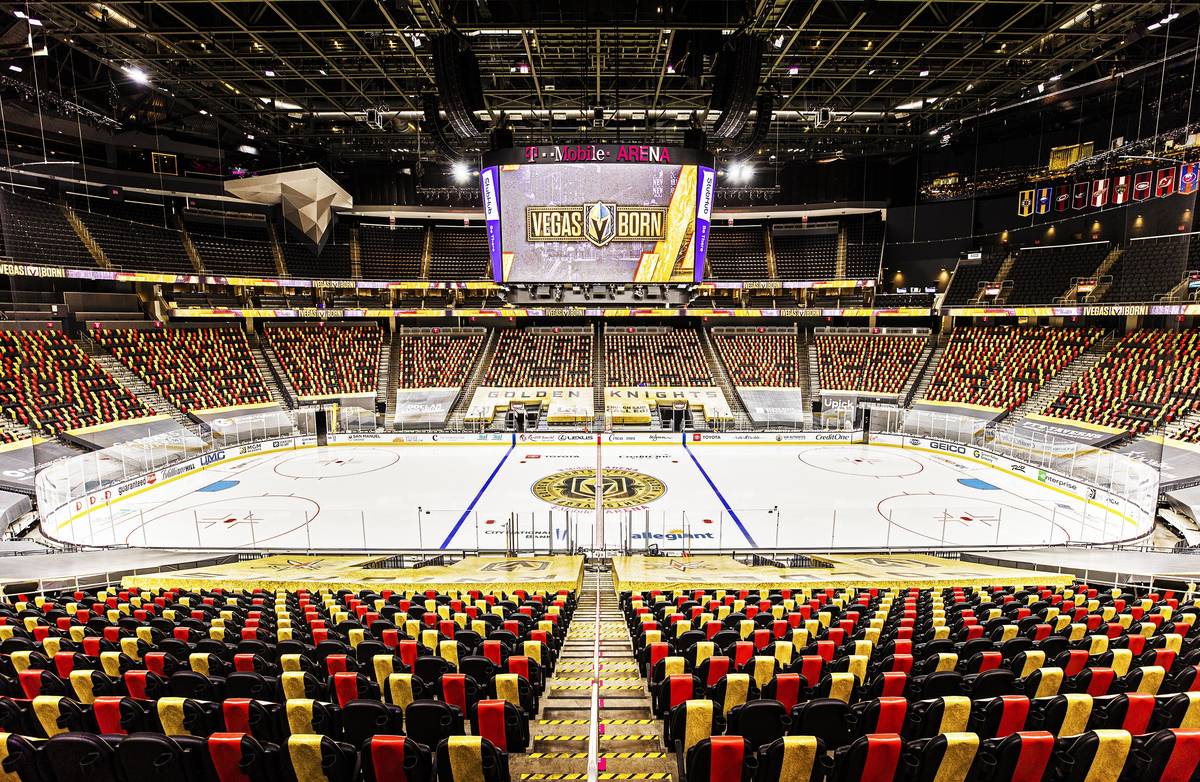 Red and gold wrapped seats provide social distance between fans at T-Mobile Arena on Thursday, ...