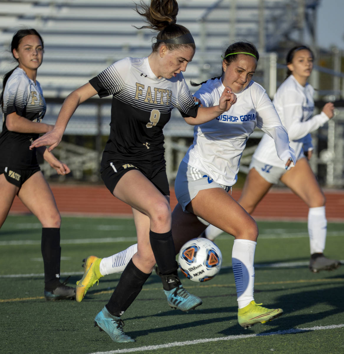 Faith Lutheran's Claire Dalbec (9) drives the ball towards the goal with Bishop Gorman's Emma C ...