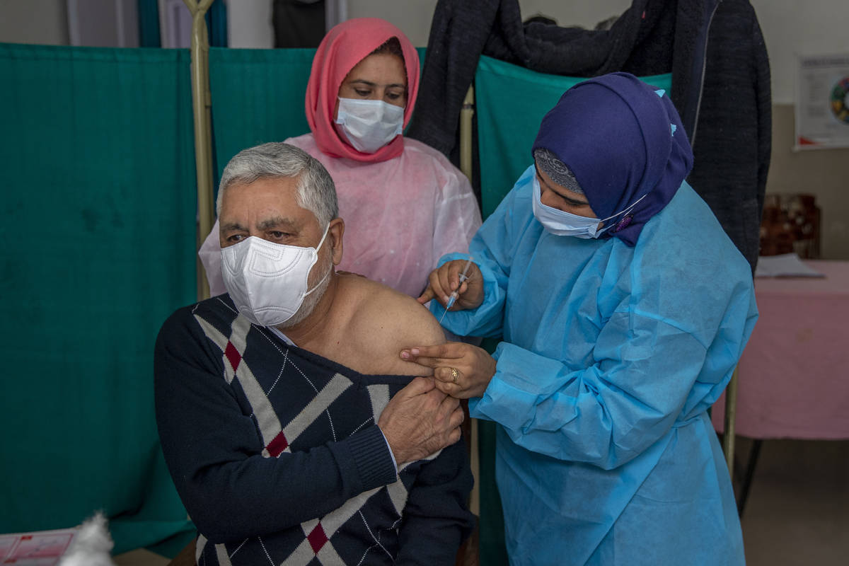 Shakeel Ahmed, a doctor, receives a shot of the Covishield vaccine at a primary health center i ...