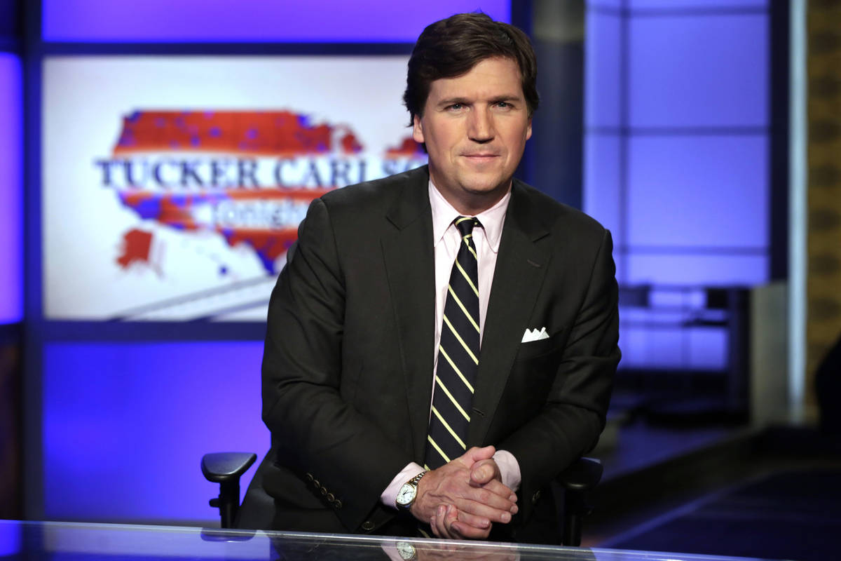 Tucker Carlson, host of "Tucker Carlson Tonight," poses for photos in a Fox News Channel studio ...