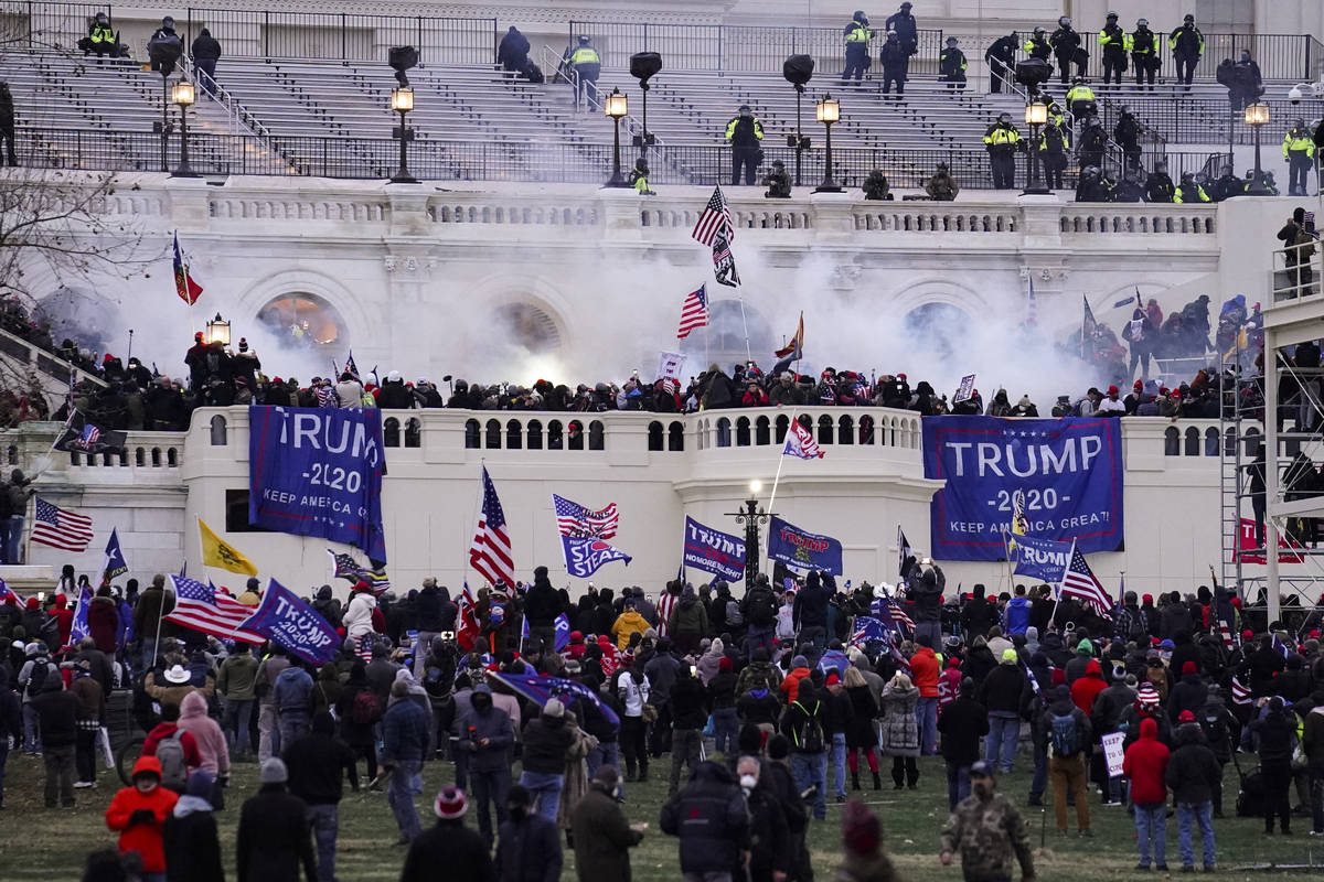 Violent protesters storm the Capitol, in Washington, Wednesday, Jan. 6, 2021. (AP Photo/John Mi ...