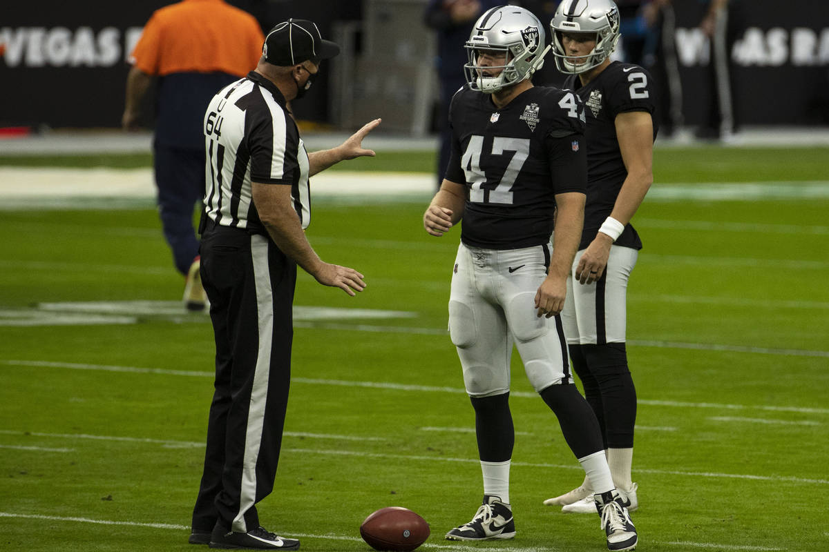 Las Vegas Raiders long snapper Trent Sieg (47) chats with umpire Dab Ferrell (64) before an NFL ...
