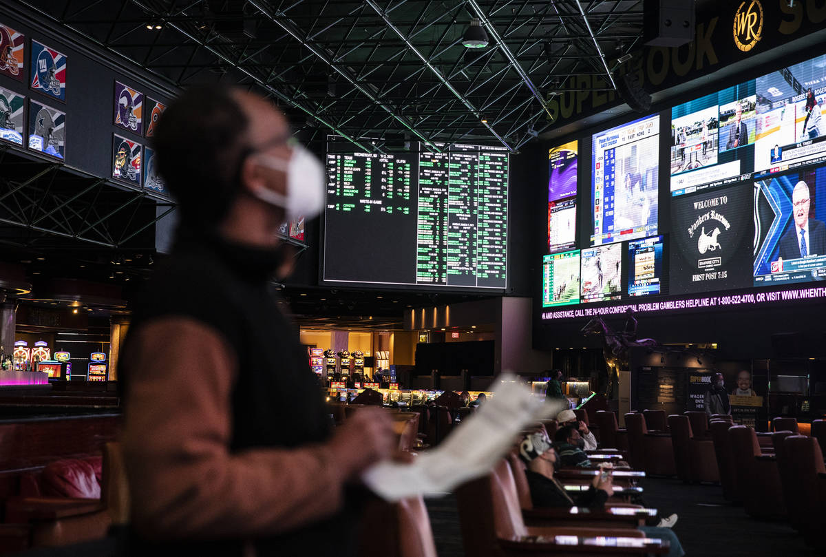 Lou Purse watches the screens at the Westgate sportsbook in Las Vegas, Wednesday, March 3, 2021 ...