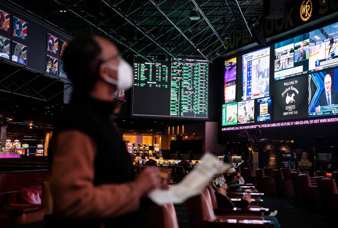 Lou Purse watches the screens at the Westgate sportsbook in Las Vegas, Wednesday, March 3, 2021 ...