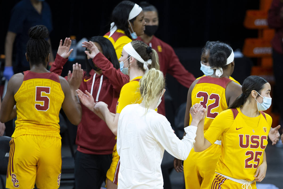 USC Trojans guard Alyson Miura (25) and guard India Otto (2) high five after winning their NCAA ...