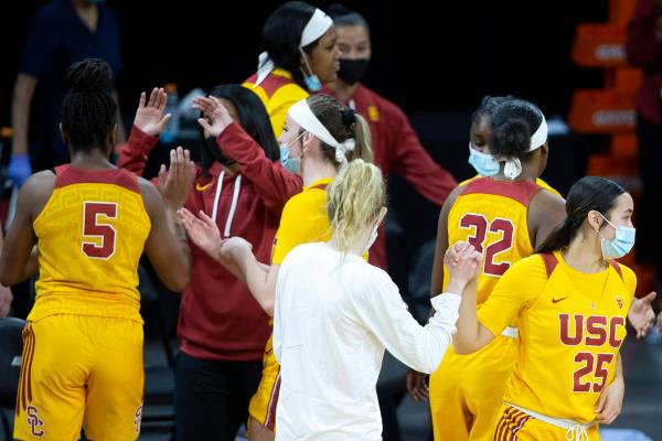 USC Trojans guard Alyson Miura (25) and guard India Otto (2) high five after winning their NCAA ...
