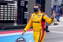 Michael McDowell walks by the championship trophy before the NASCAR Daytona 500 auto race at Da ...