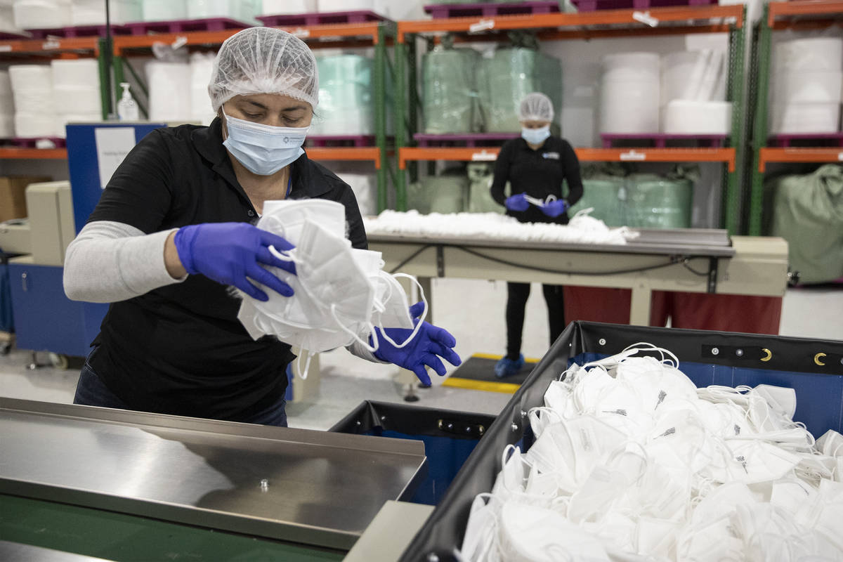 Manufacturing technician Sheyna Rocha checks for N95 mask quality at the PandMedic Solutions he ...