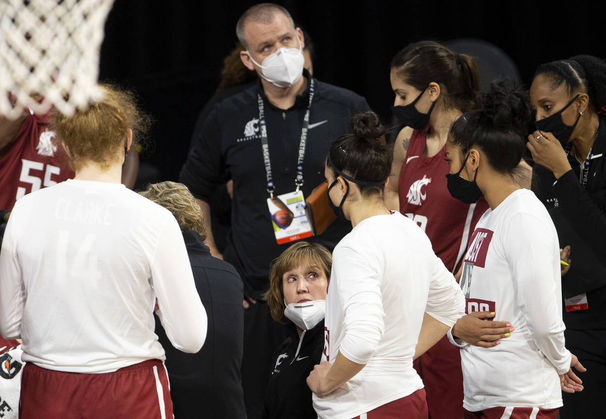 Washington State Cougars head coach Kamie Ethridge communicates with her team in a time out dur ...