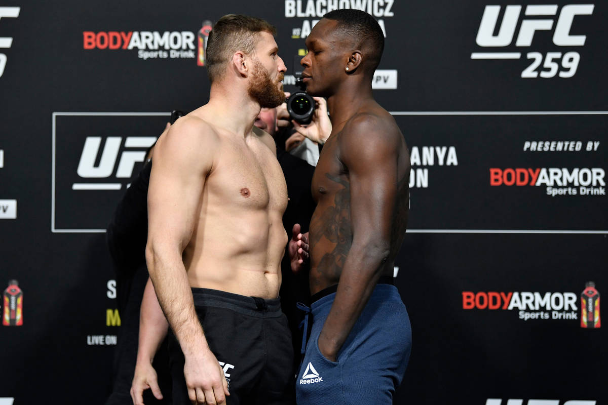 Jan Blachowicz of Poland, left, and Israel Adesanya of Nigeria face off during the UFC 259 weig ...