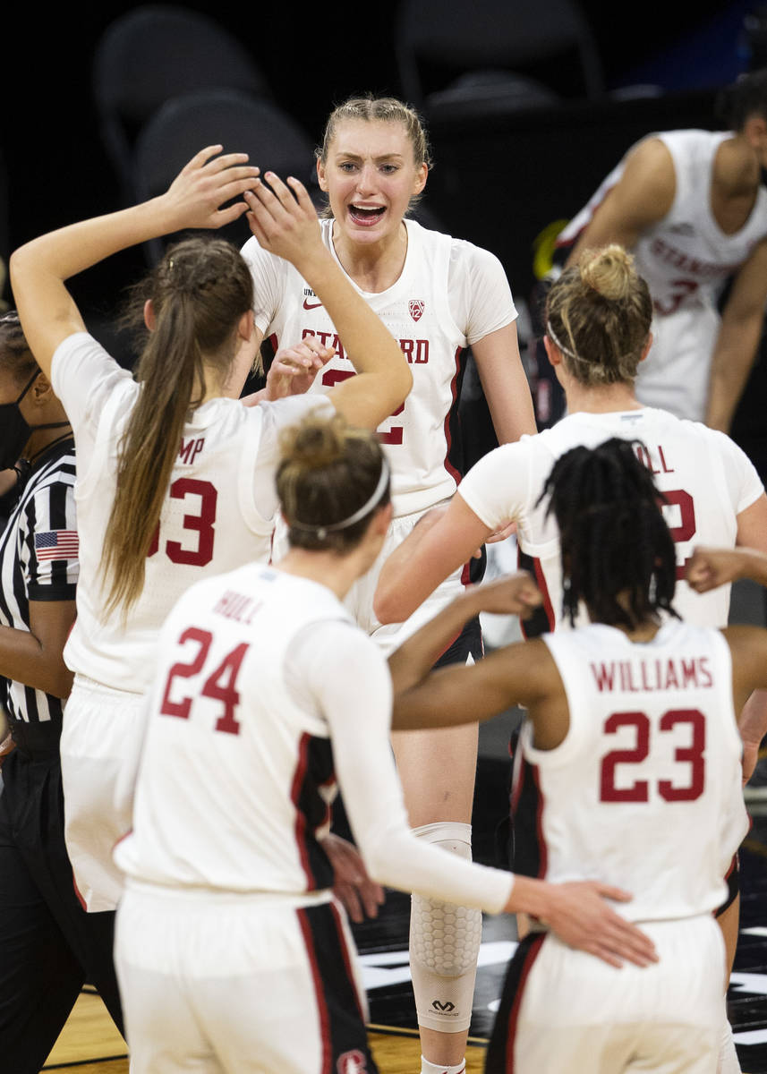 Stanford Cardinal forward Cameron Brink (22), center, celebrates scoring with several of her te ...