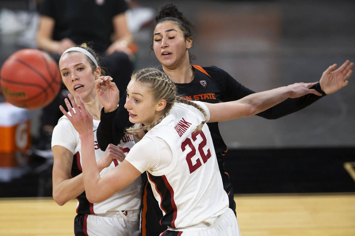 Stanford Cardinal guard Lexie Hull (12), left, and forward Cameron Brink (22) fall back after a ...