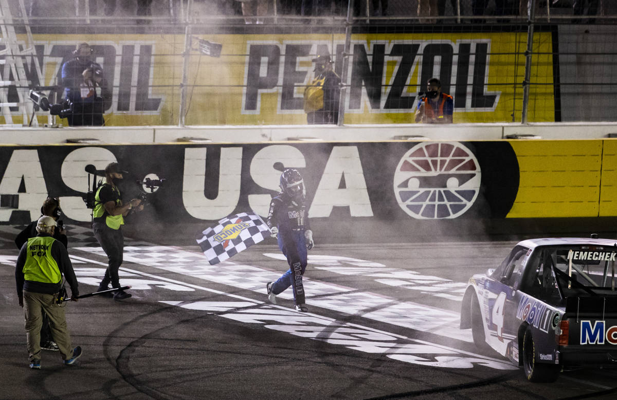 John Nemechek celebrates with the checkered flag after winning a NASCAR Camping World Truck Ser ...