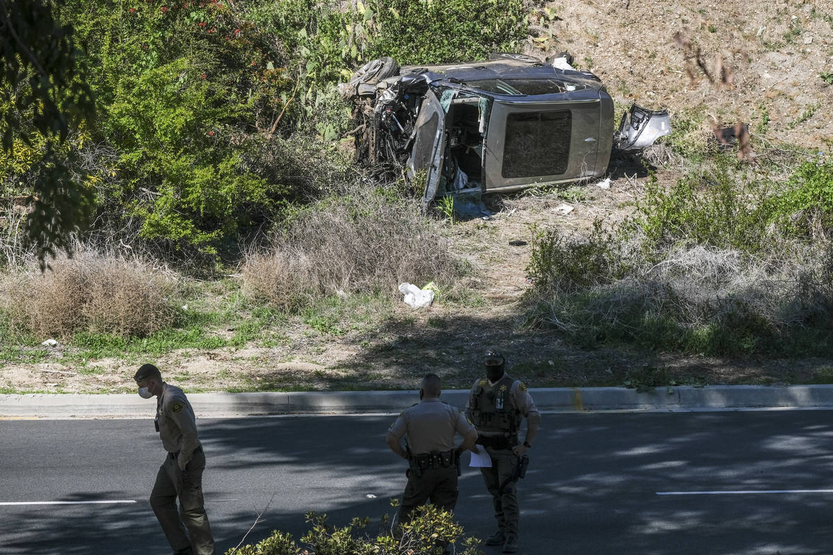 A vehicle rests on its side after a rollover accident involving golfer Tiger Woods along a road ...