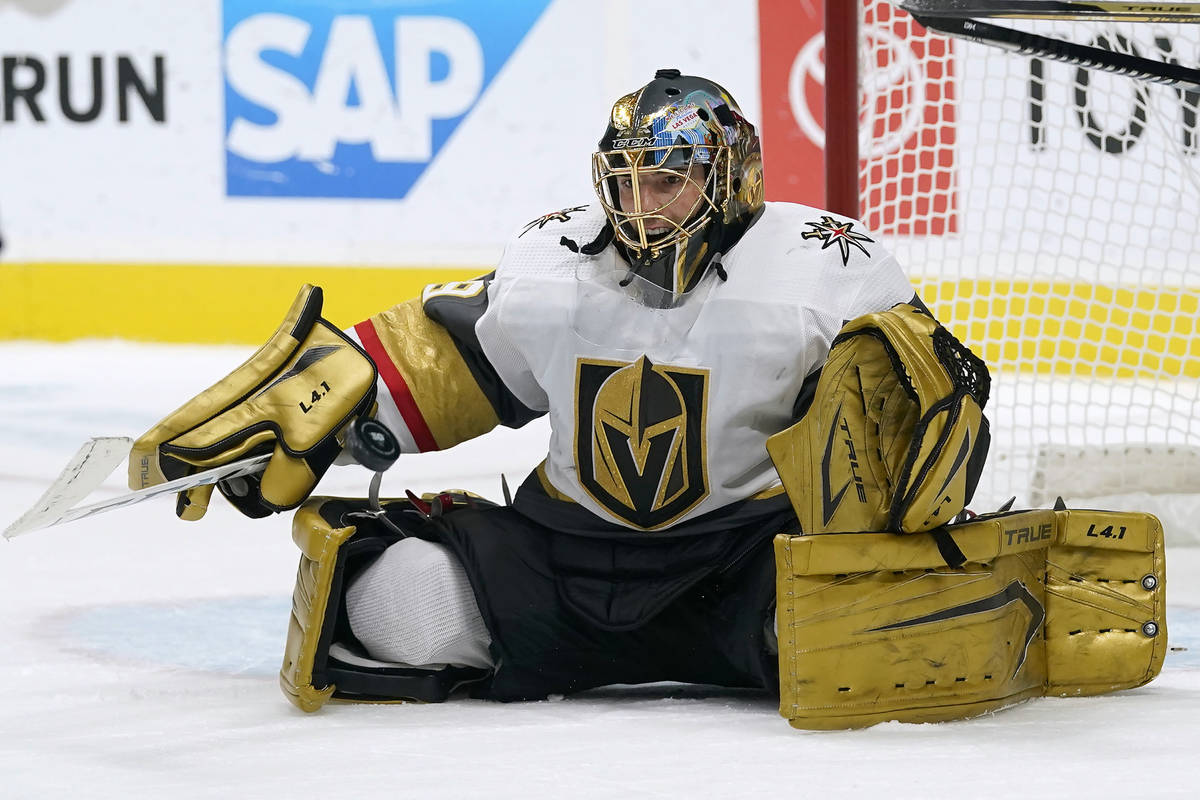 Vegas Golden Knights goaltender Marc-Andre Fleury defends on a shot by the San Jose Sharks duri ...