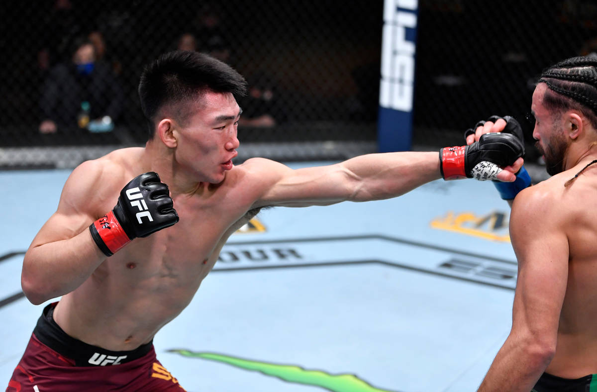 LAS VEGAS, NEVADA - MARCH 06: (L-R) Song Yadong of China punches Kyler Phillips in their bantam ...