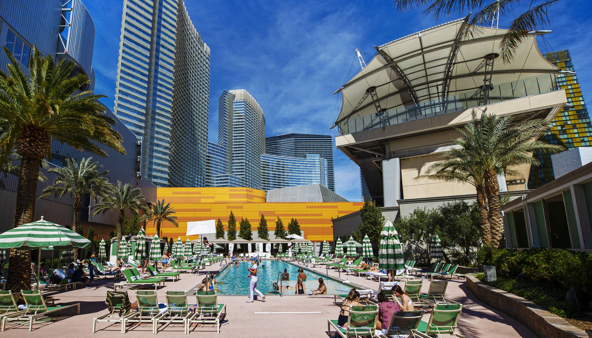 Guests lounge by the pool at Park MGM on Saturday, March 6, 2021, in Las Vegas. (Benjamin Hager ...