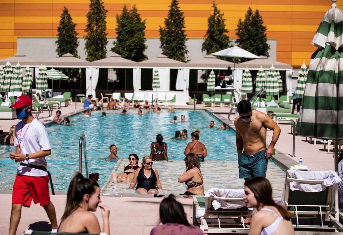 Guests lounge by the pool at Park MGM on Saturday, March 6, 2021, in Las Vegas. (Benjamin Hager ...