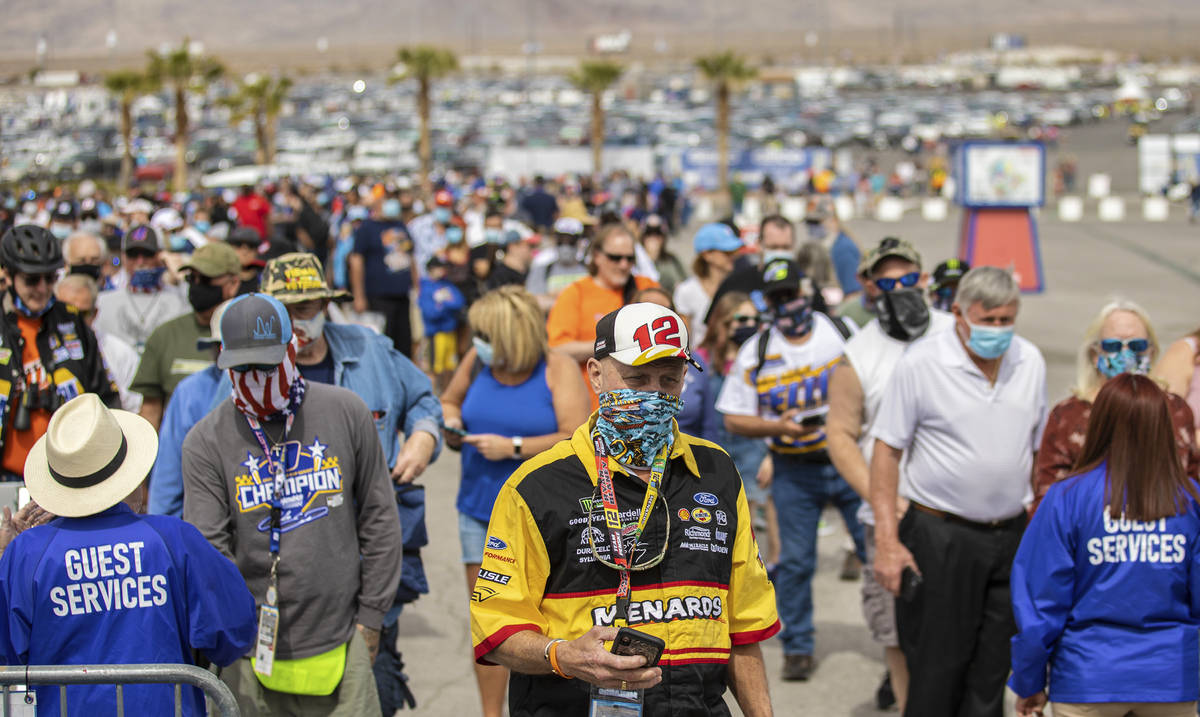 NASCAR fans get their tickets scanned before the start of the NASCAR Cup Series Pennzoil 400 a ...