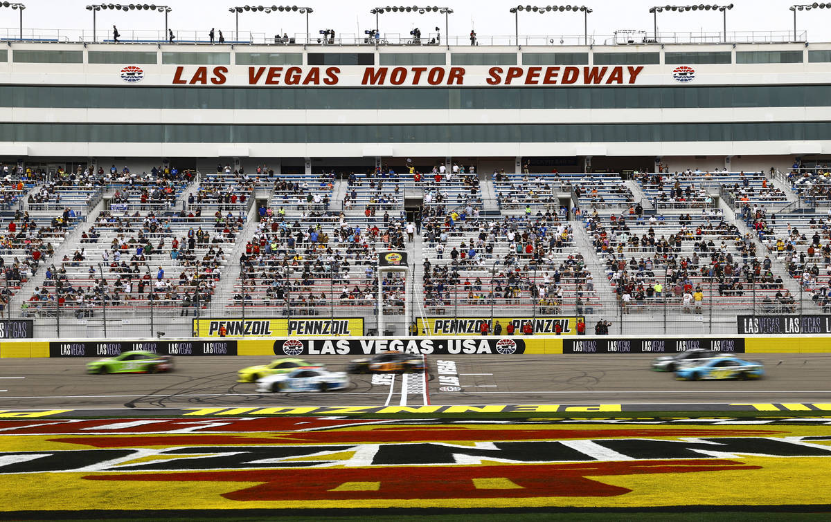 Drivers pass the start/finish line during a NASCAR Cup Series Pennzoil 400 auto race at the Las ...