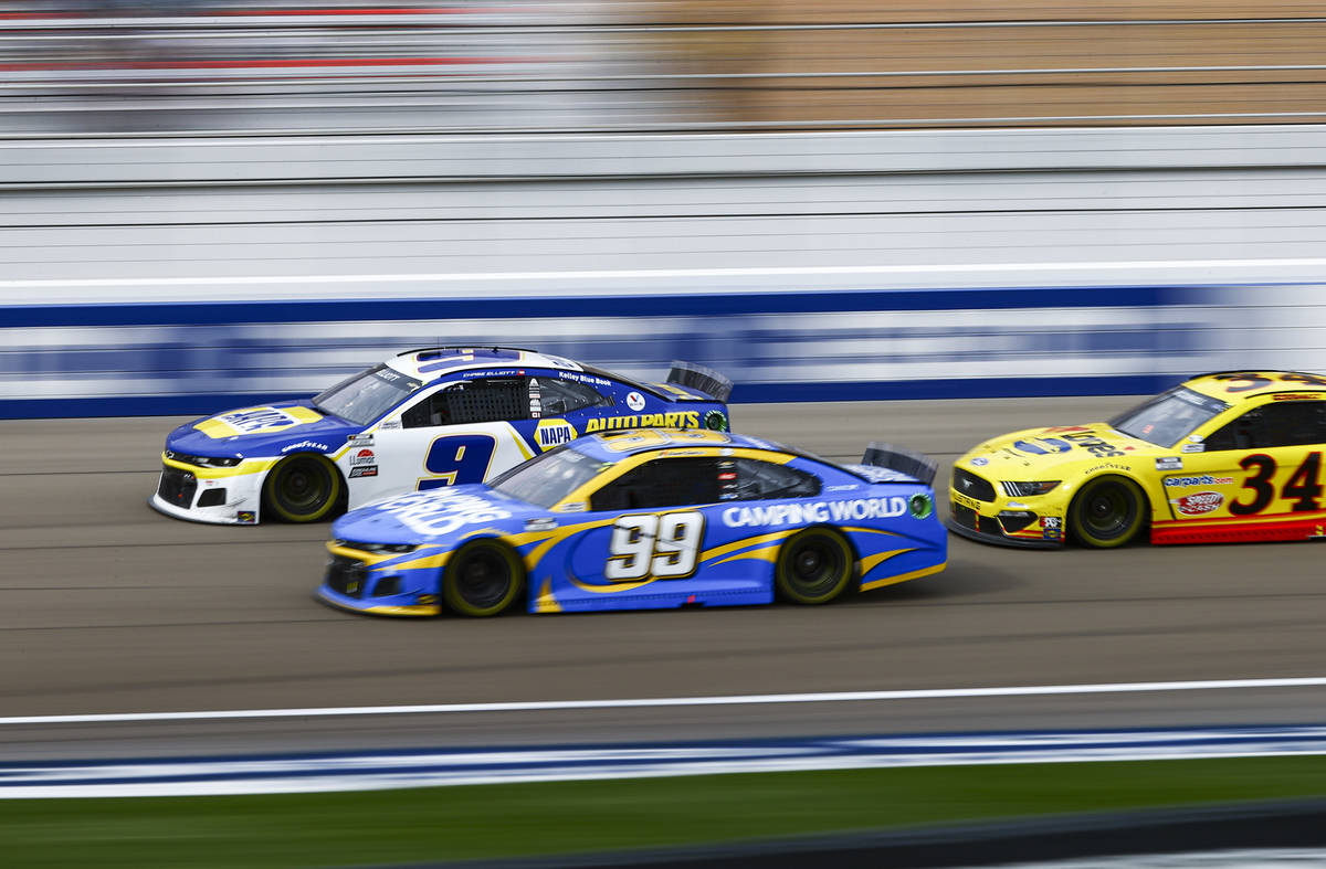 Chase Elliott (9) and Daniel Suarez (99) fight for position in front of Michael McDowell (34) d ...