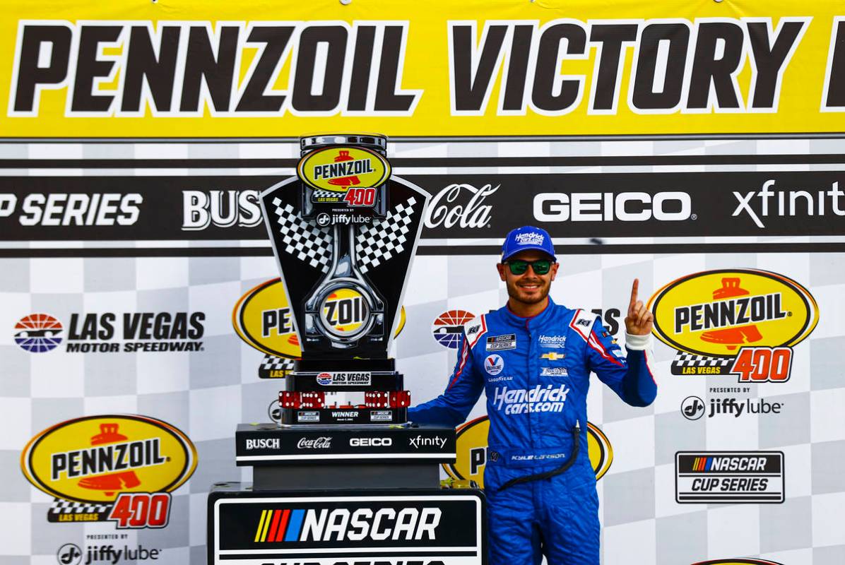 Kyle Larson poses with the trophy after winning the NASCAR Cup Series Pennzoil 400 auto race at ...