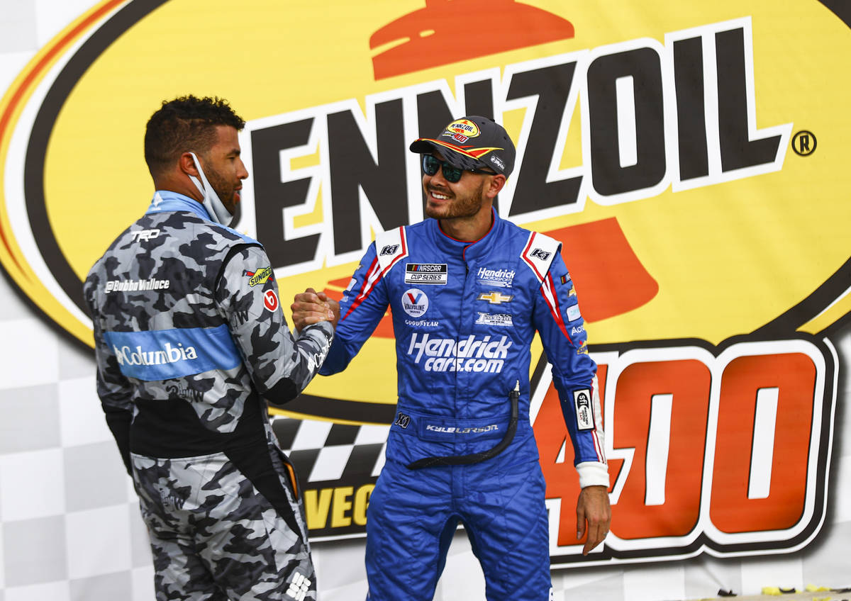 Bubba Wallace, left, congratulates Kyle Larson on his win in the NASCAR Cup Series Pennzoil 400 ...