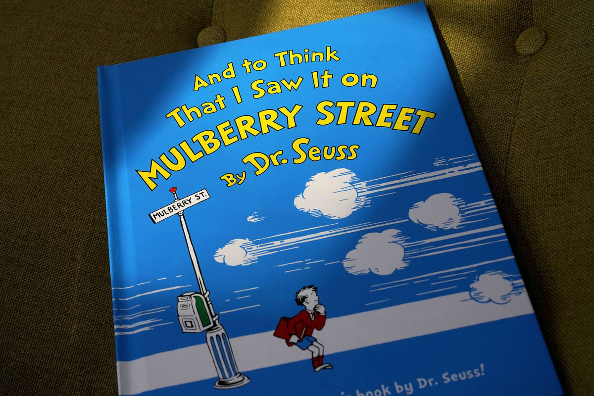 A copy of the book "And to Think That I Saw It on Mulberry Street," by Dr. Seuss, rests in a ch ...