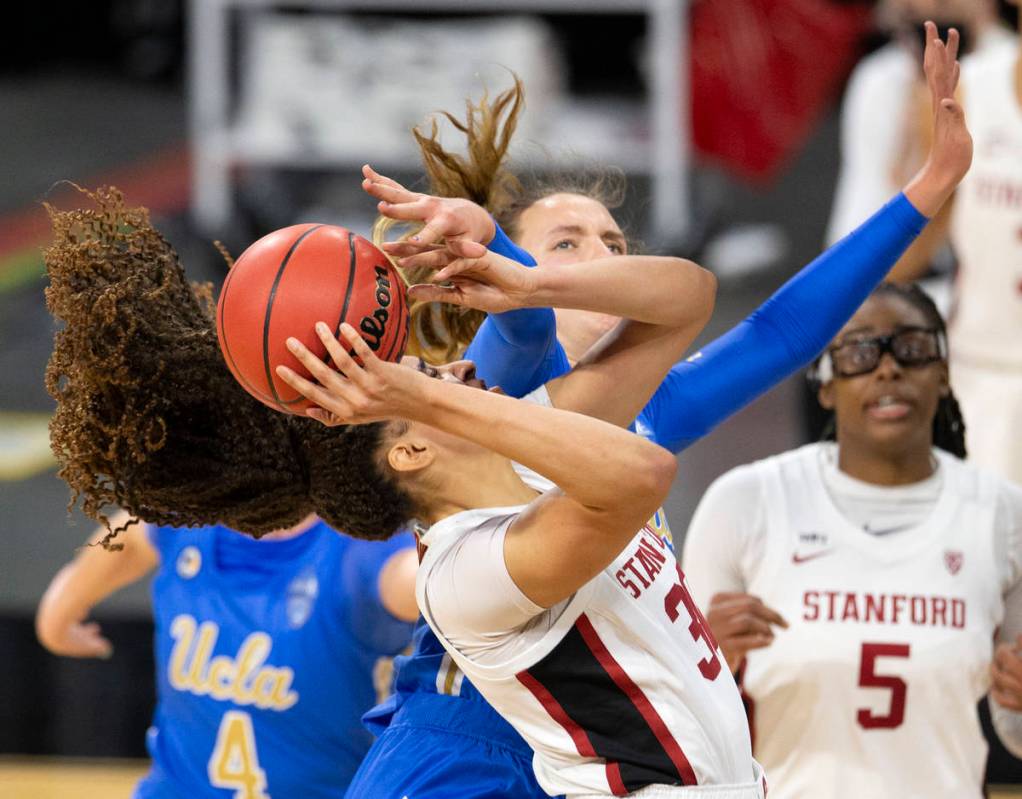 Stanford Cardinal guard Anna Wilson (3) attempts a point while UCLA Bruins forward Emily Bessoi ...