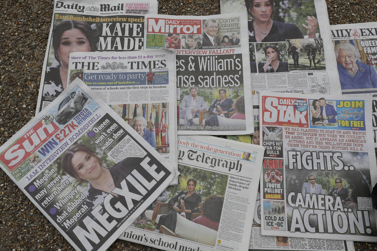 Newspapers are placed on the ground placed by a television crew in front of Buckingham Palace i ...