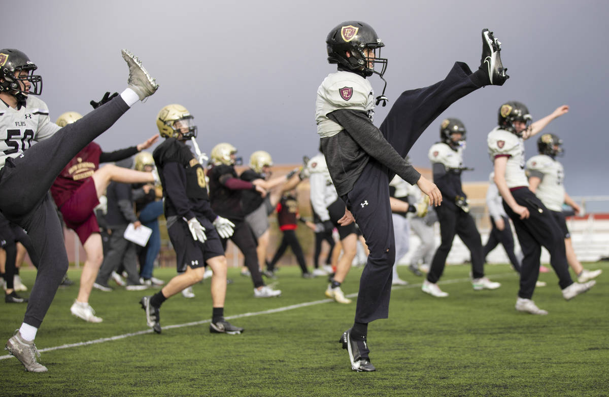 Faith Lutheran football players warm up before the start of practice on Thursday, March 11, 202 ...